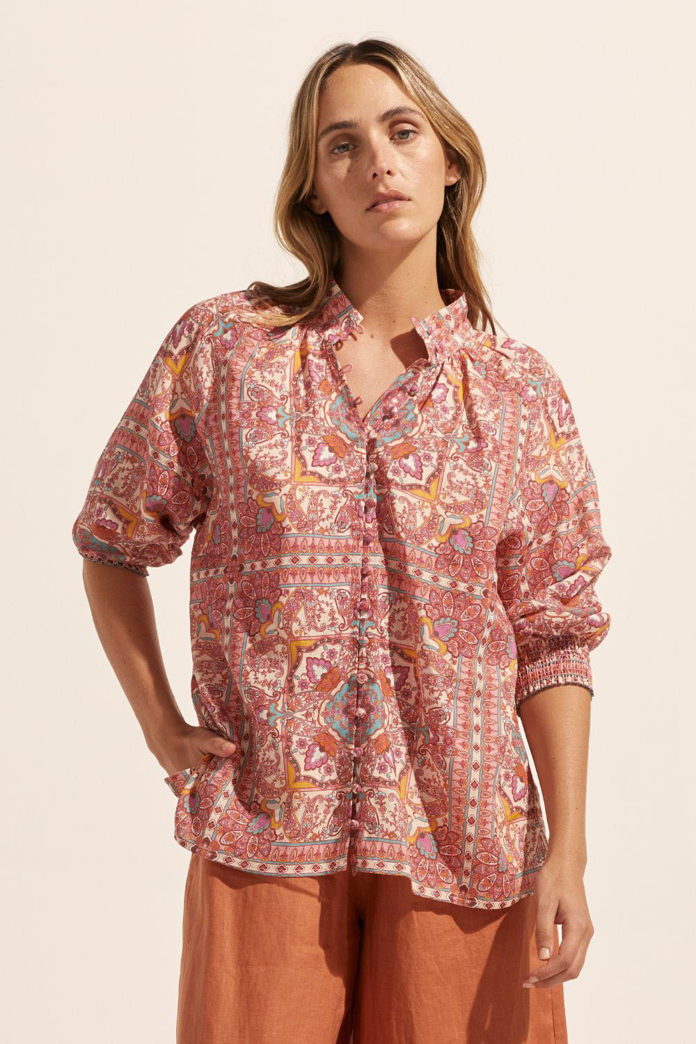 pink print, medium length sleeve, buttons down centre, small side splits, high neck, front image