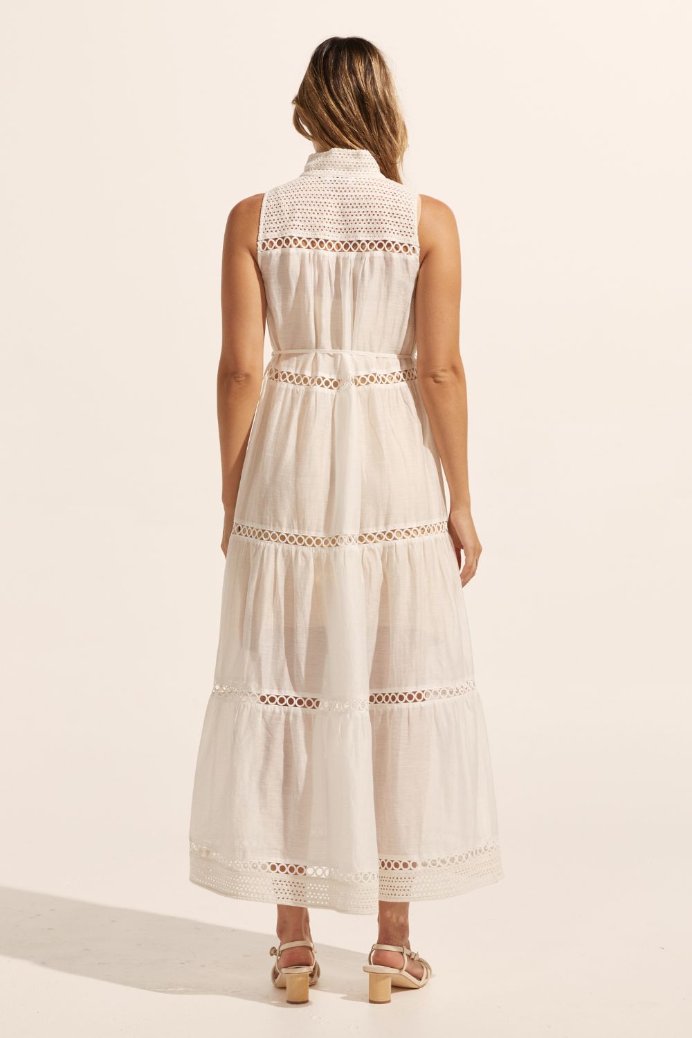white, maxi dress, sleeveless, button down centre, high neck, circular lace design, self tie fabric belt, back image
