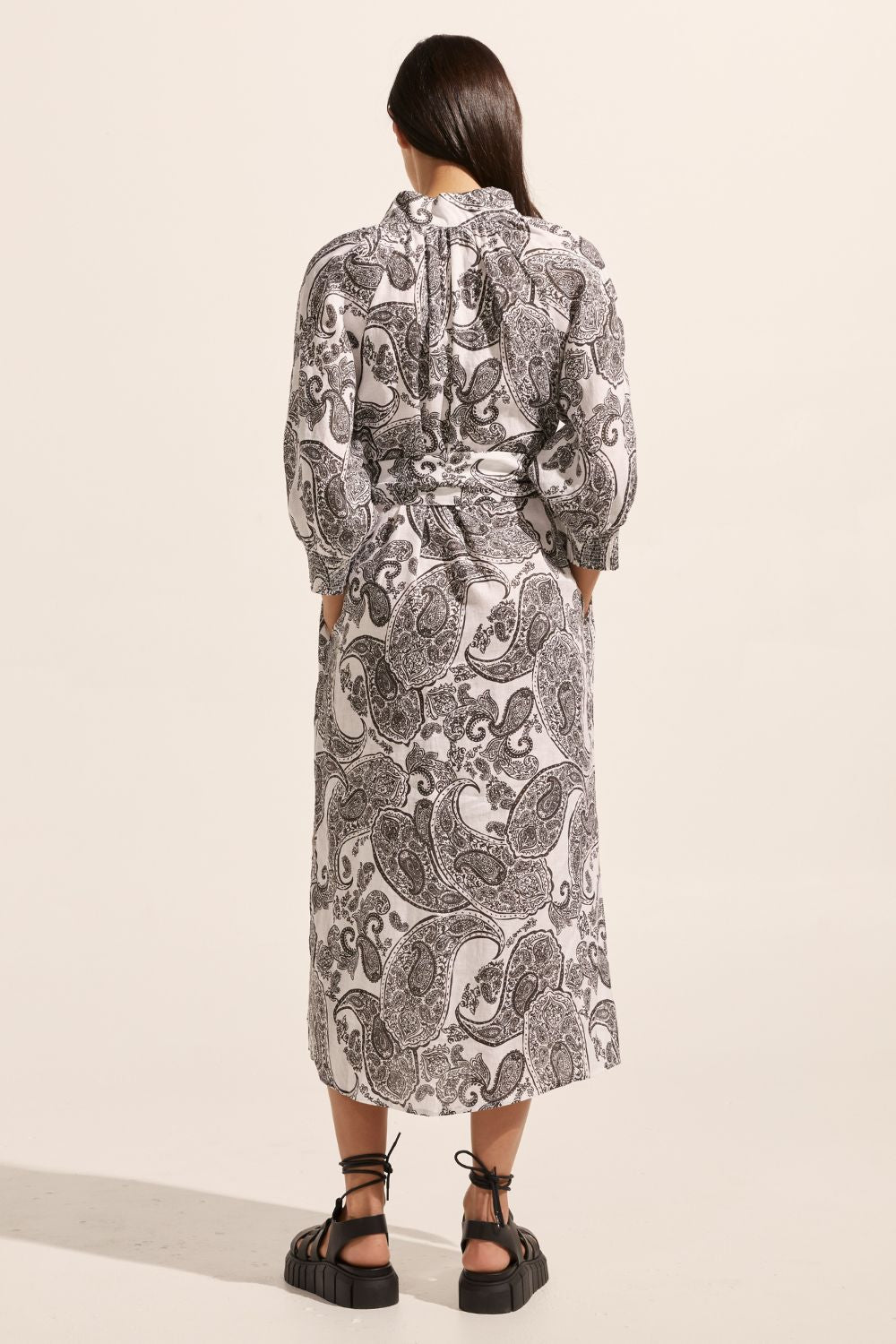 black and white print, self tie fabric belt, high neck, mid length sleeve, midi dress, side pockets, back view