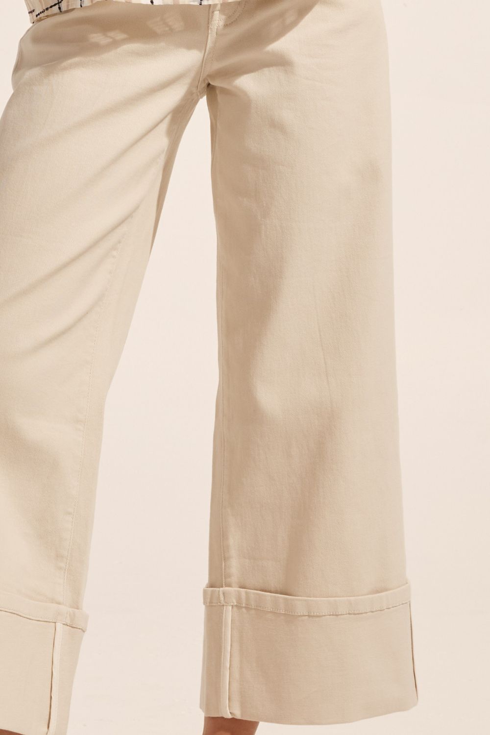 cream, pant, wide leg, deep cuff at hem, denim, high waist, close up image