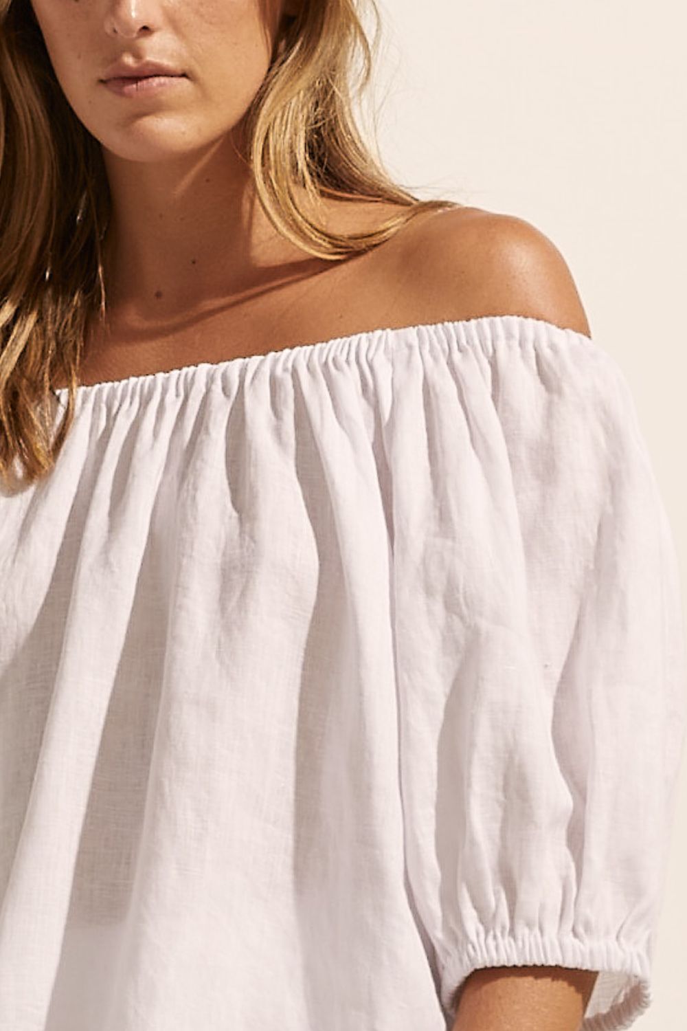 white, top, off-the-shoulder, mid-length sleeve, small side splits, elasticated sleeve cuff, tie at back, close up image
