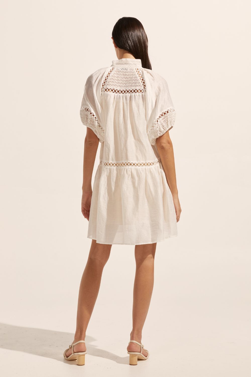 white, high neck, covered buttons, circular lace detailing, drop waist, mid-length sleeve, mini dress, back image