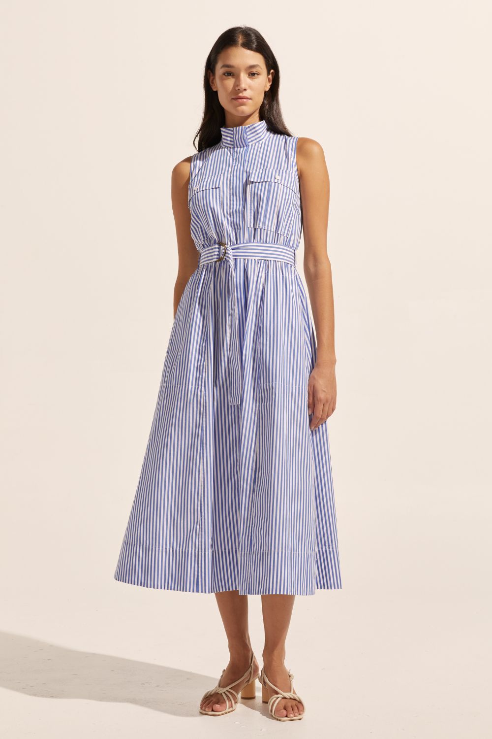 blue and white stripe, high neckline, side pockets, oversized patch pockets, covered placket, d-ring fabric belt, sleeveless, midi dress, front image