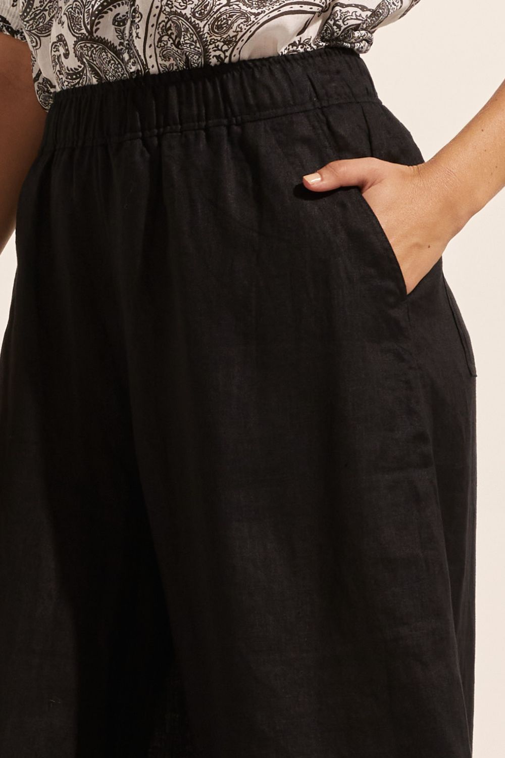 black, pants, elasticated waist, side pockets, wide leg, close up image