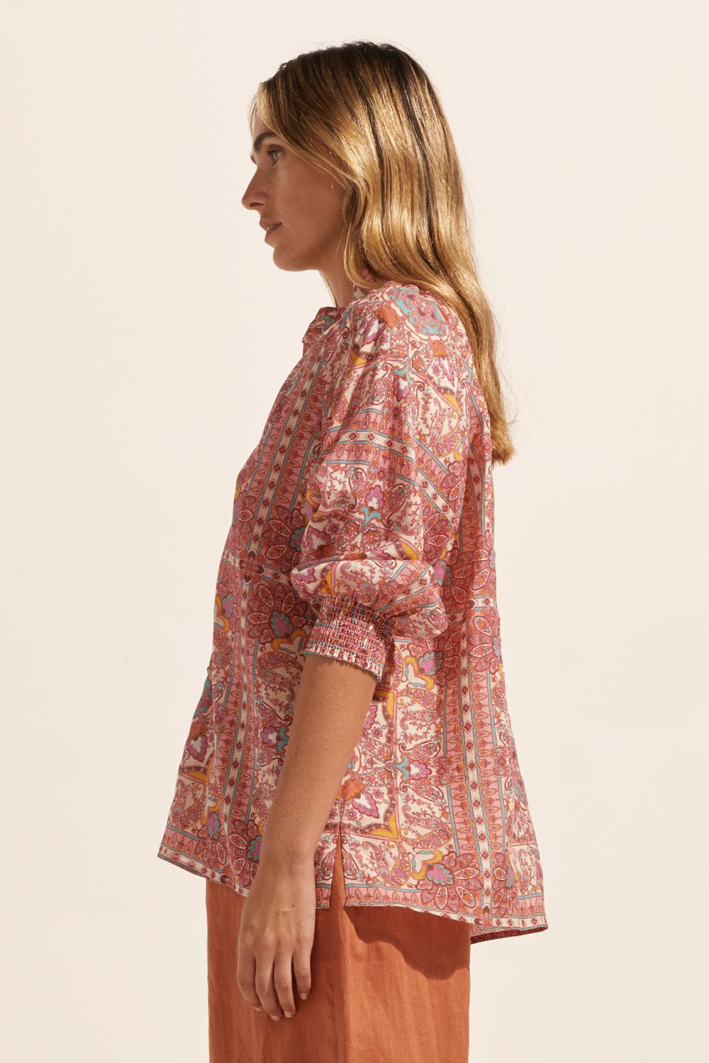 pink print, medium length sleeve, buttons down centre, small side splits, high neck, side image