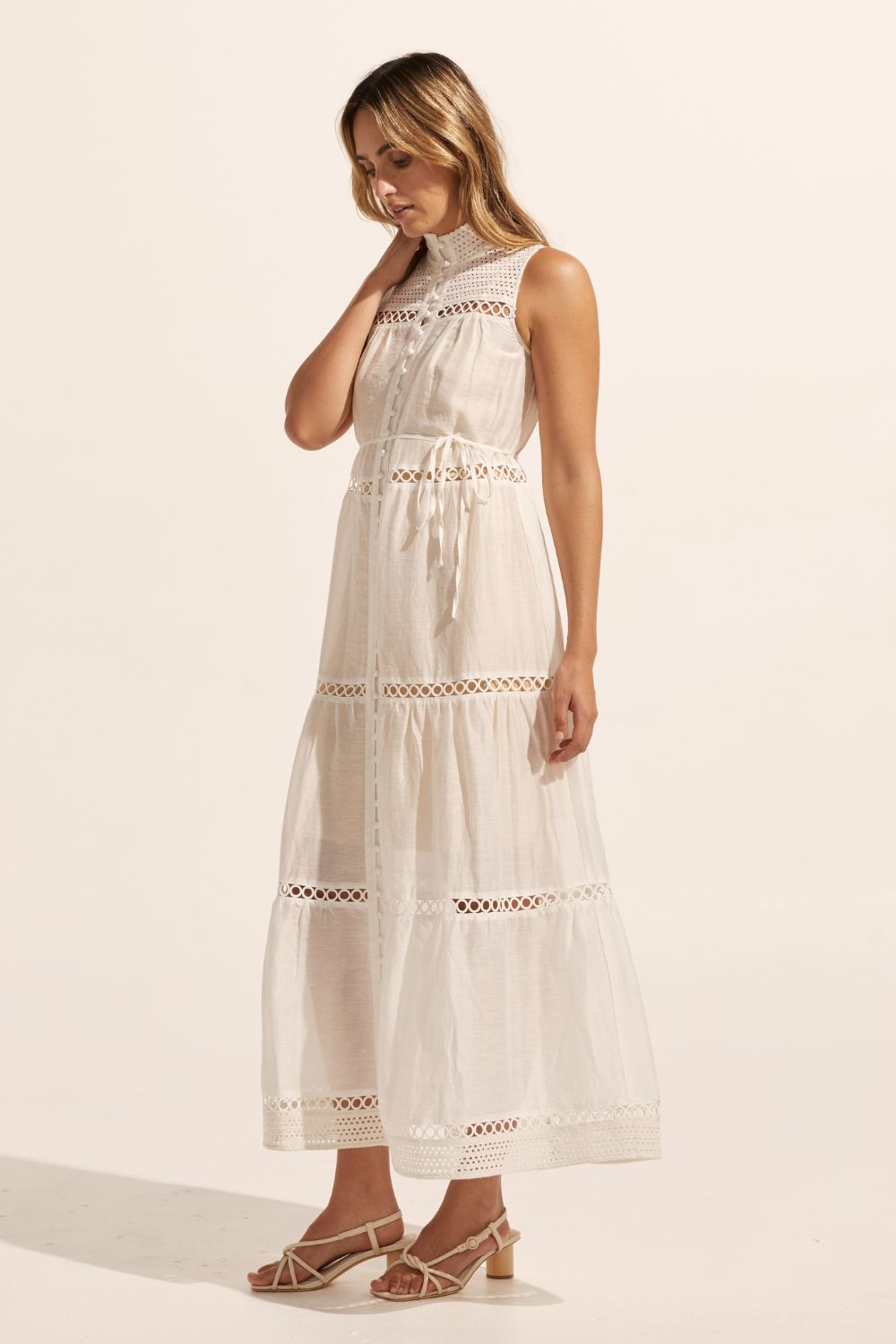 white, maxi dress, sleeveless, button down centre, high neck, circular lace design, self tie fabric belt, side image