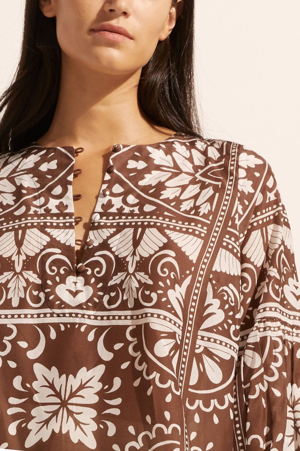 brown and white print, rounded neckline, mid length sleeve, close up view