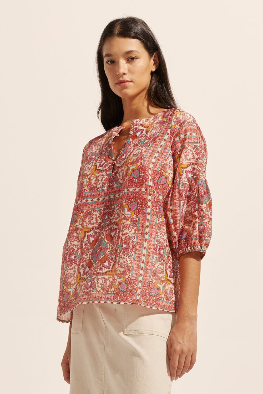 pink print, mid length sleeve, round neckline, covered buttons, small side splits, top, side image