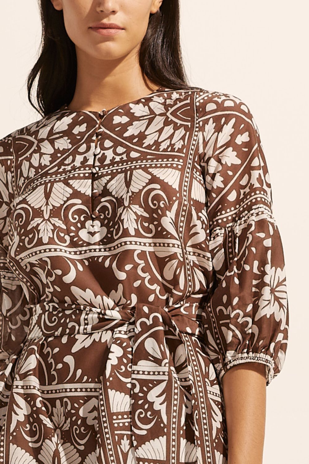 brown and white print, fabric self tie belt, mid length sleeve, rounded neckline, side splits, close up view