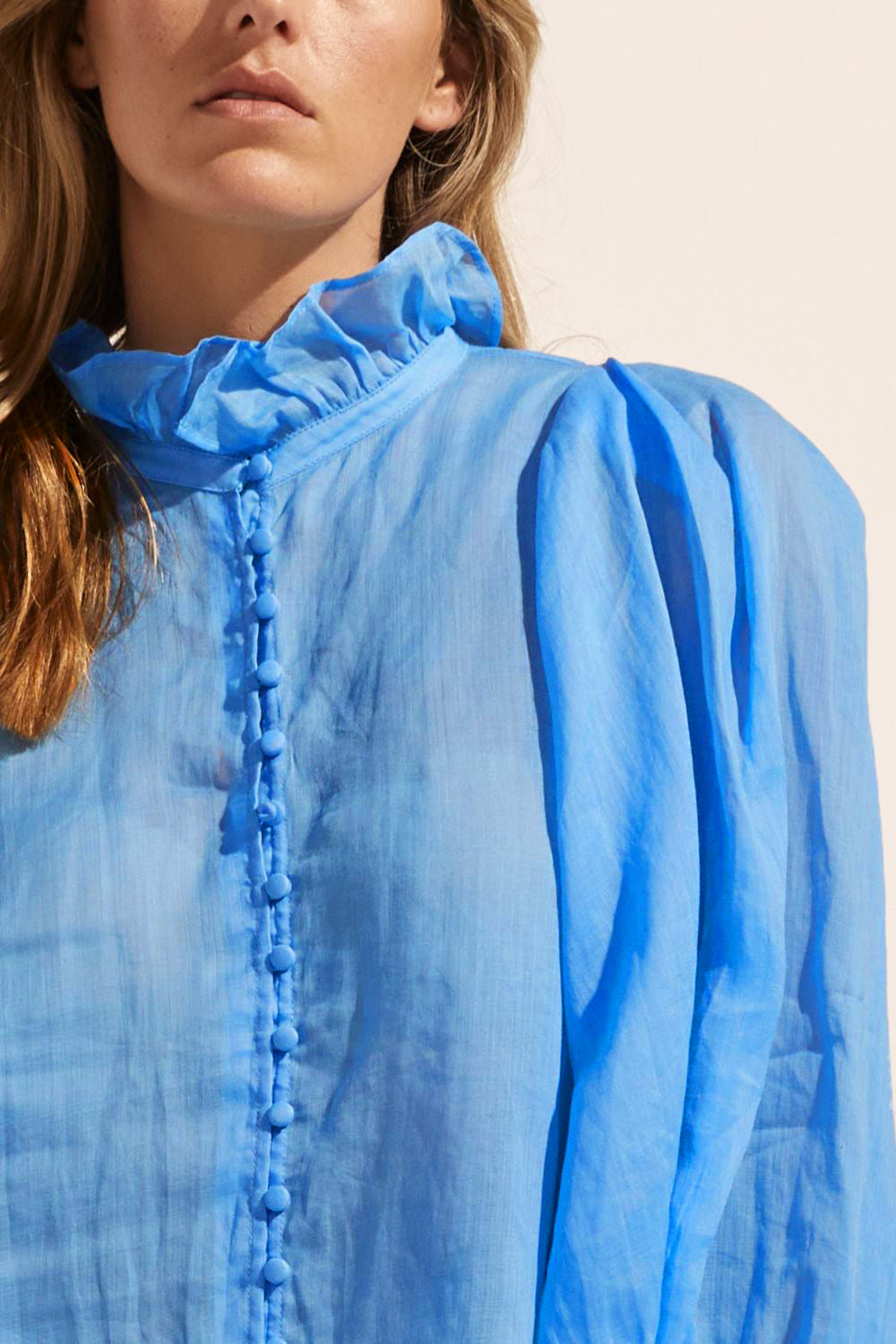 blue, ruffle neck collar, buttons down centre, mid length sleeve, shirt, close up view