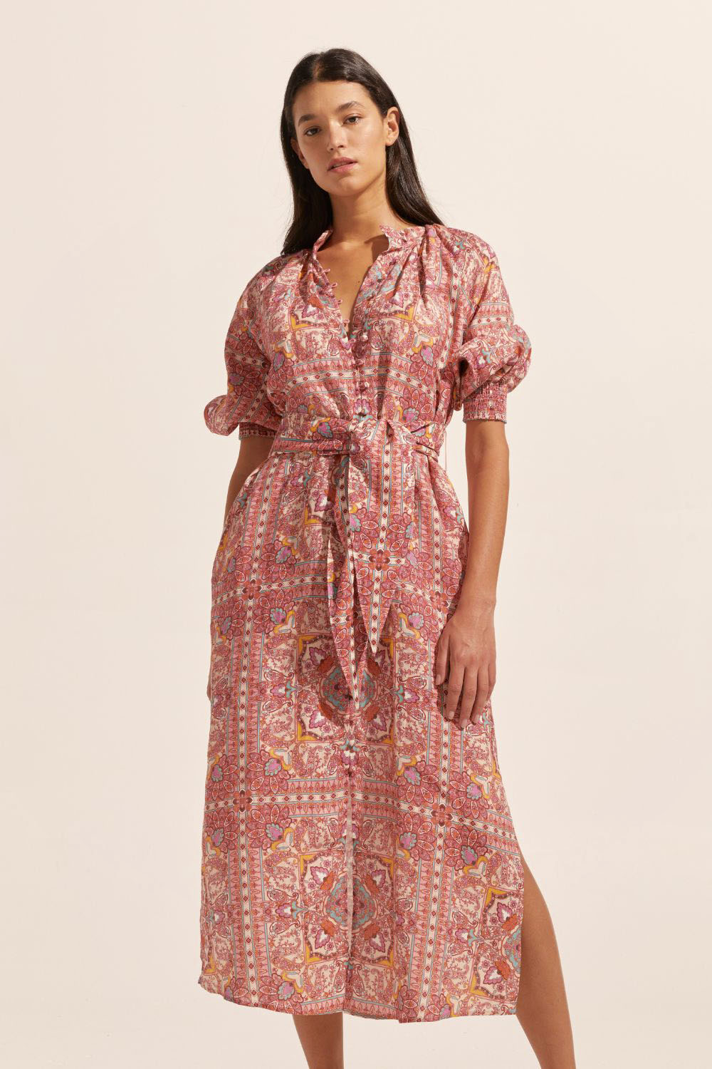 pink print, high neck, covered buttons down centre, self tie fabric belt, elasticated sleeve cuff, mid length sleeve, side splits, midi dress, front image