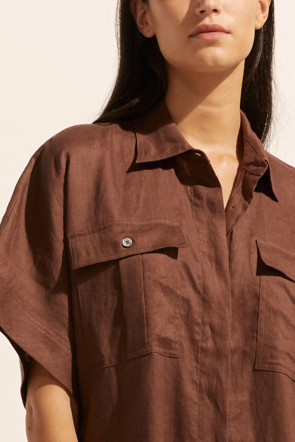 brown, jumpsuit, button down collar, oversized patch pockets, close up view
