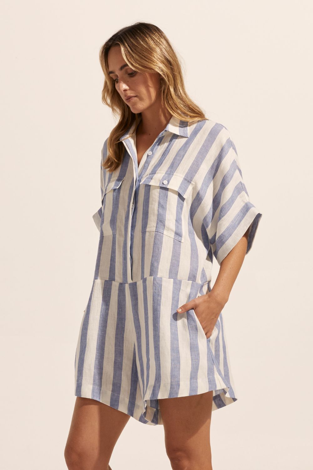 blue and white stripe, jumpsuit, button down collar, oversized patch pockets, side view