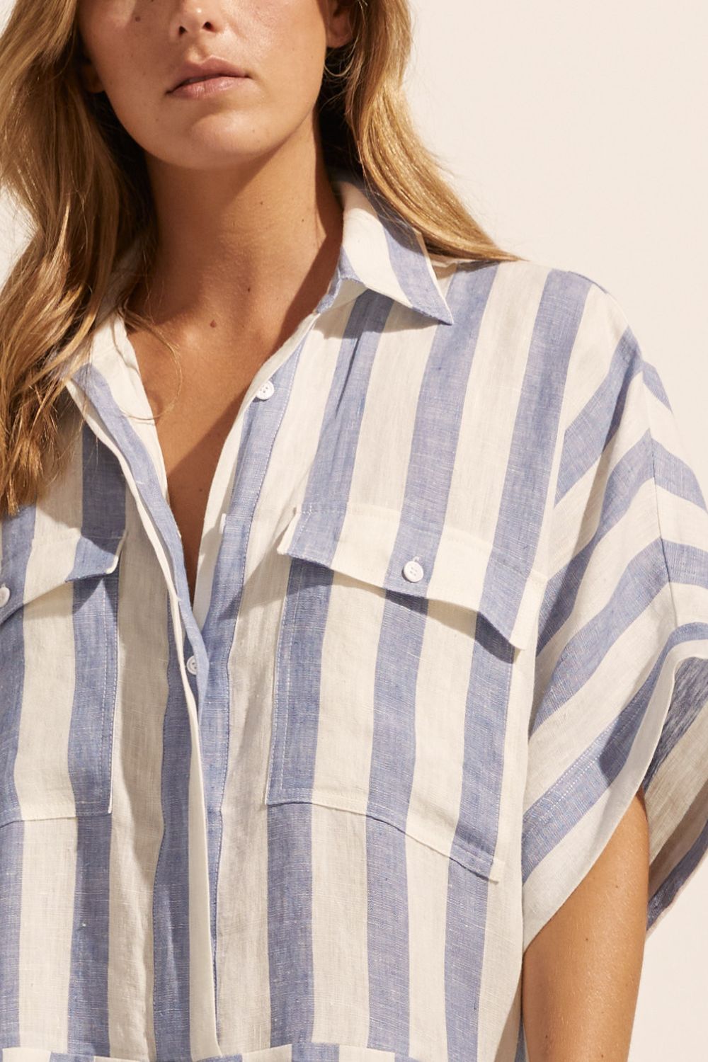 blue and white stripe, jumpsuit, button down collar, oversized patch pockets, close up view