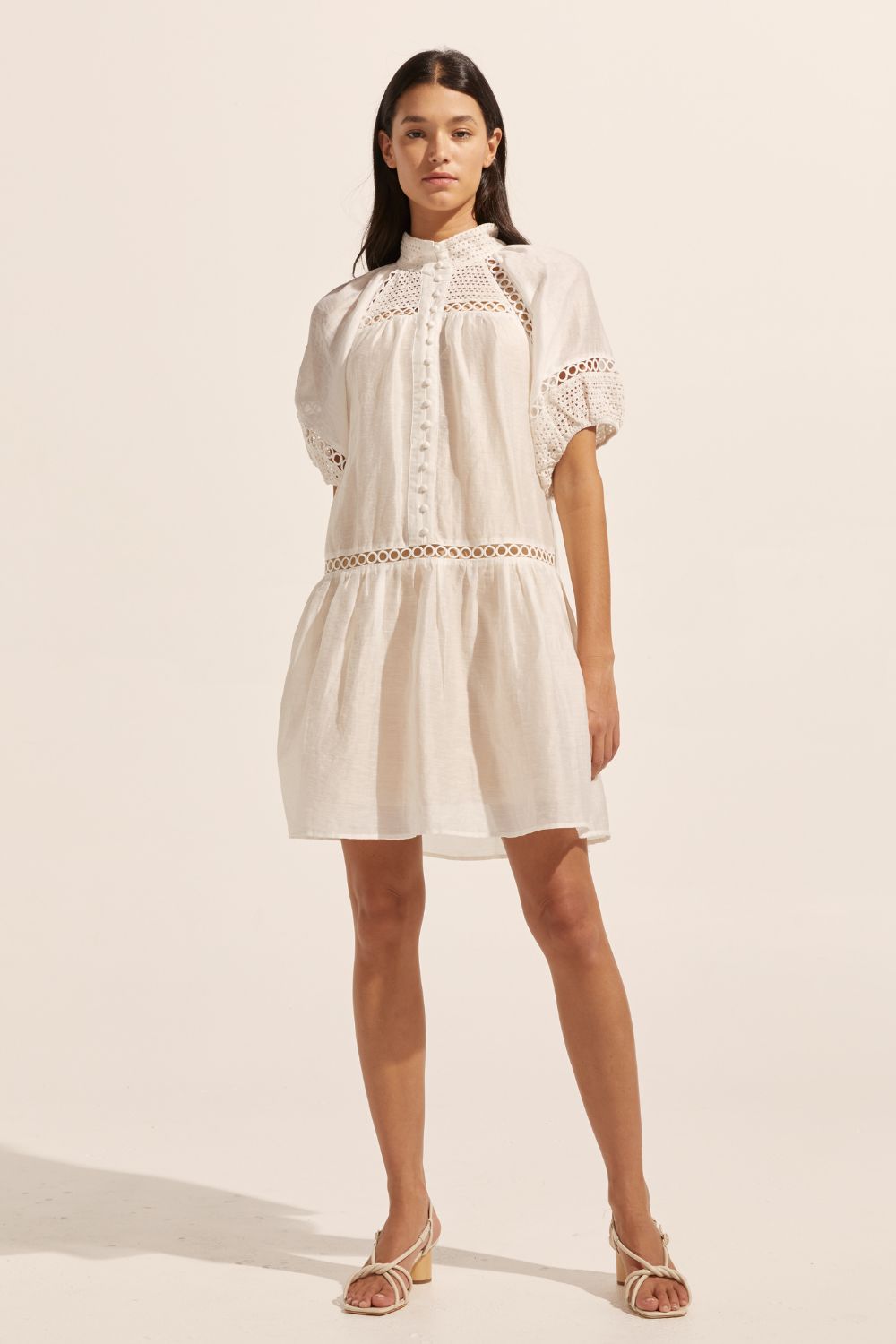 white, high neck, covered buttons, circular lace detailing, drop waist, mid-length sleeve, mini dress, front image