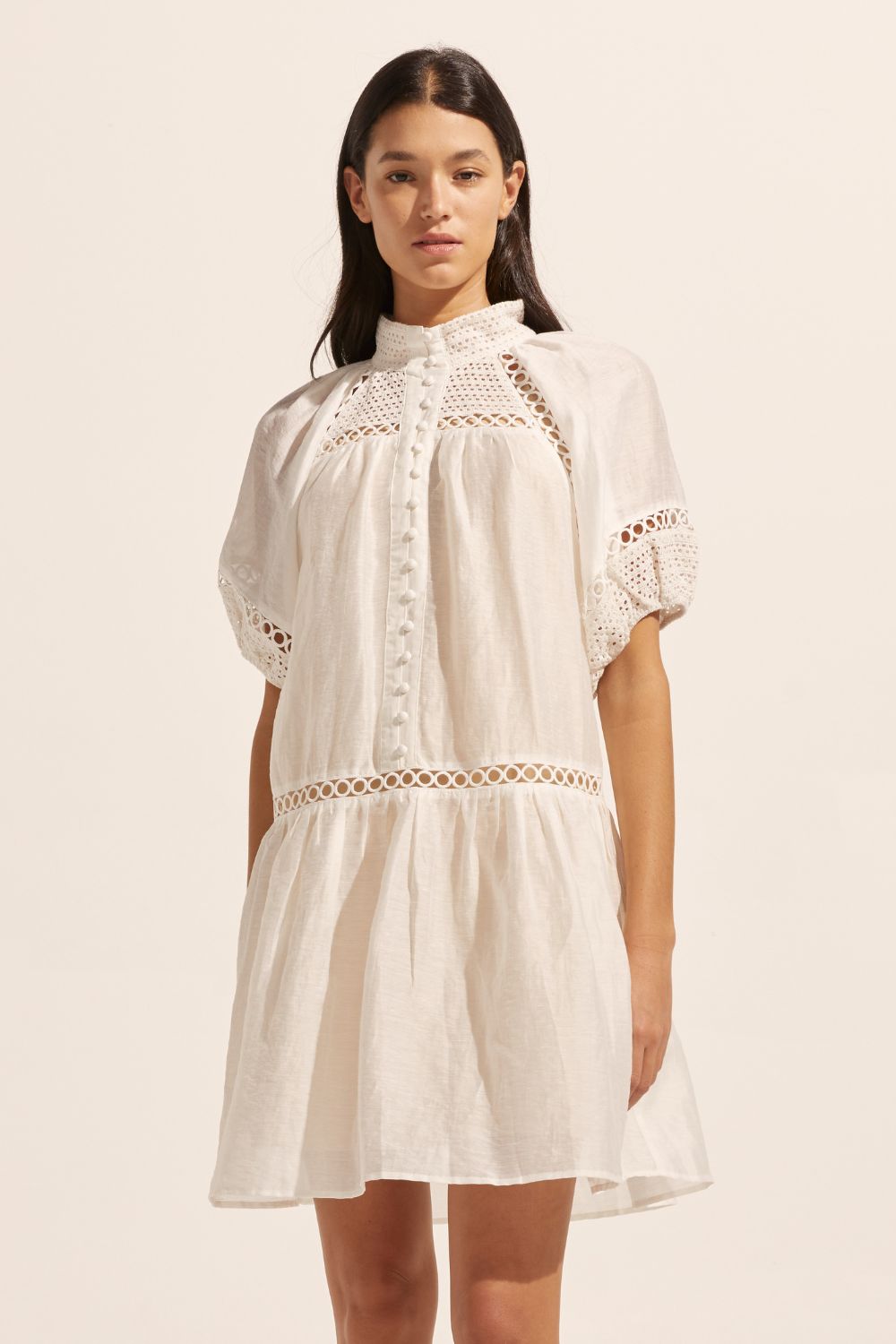 white, high neck, covered buttons, circular lace detailing, drop waist, mid-length sleeve, mini dress, front image