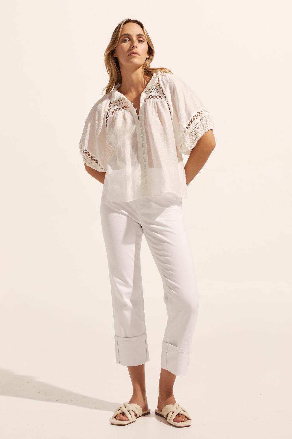 white, top, high neck, mid-length sleeve, covered buttons, circular lace detailing, front image