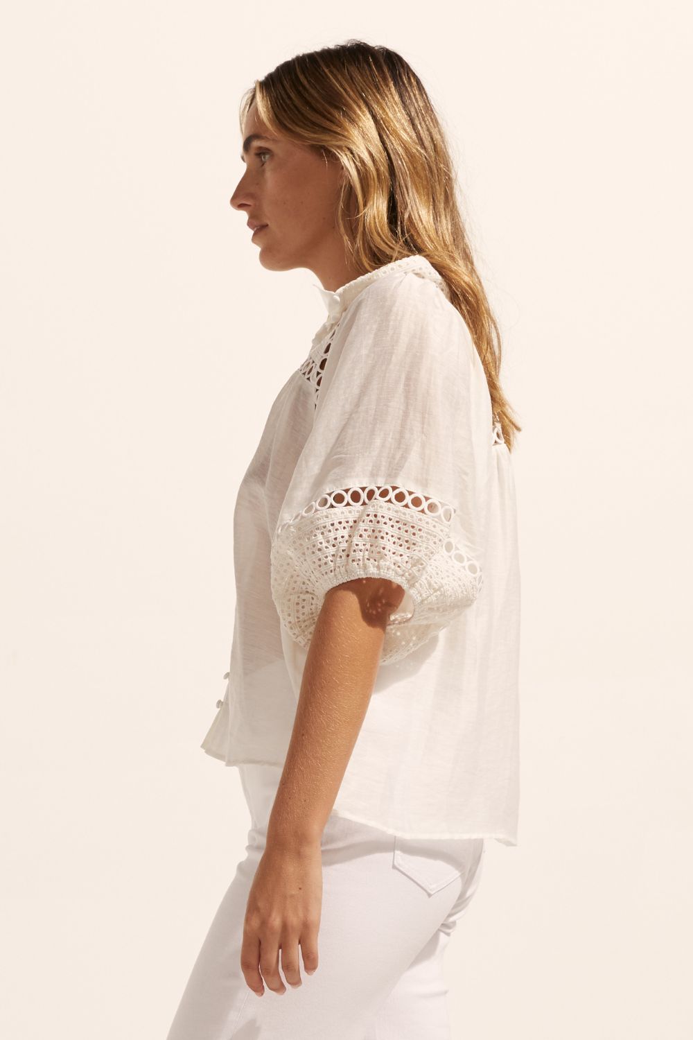 white, top, high neck, mid-length sleeve, covered buttons, circular lace detailing, side image