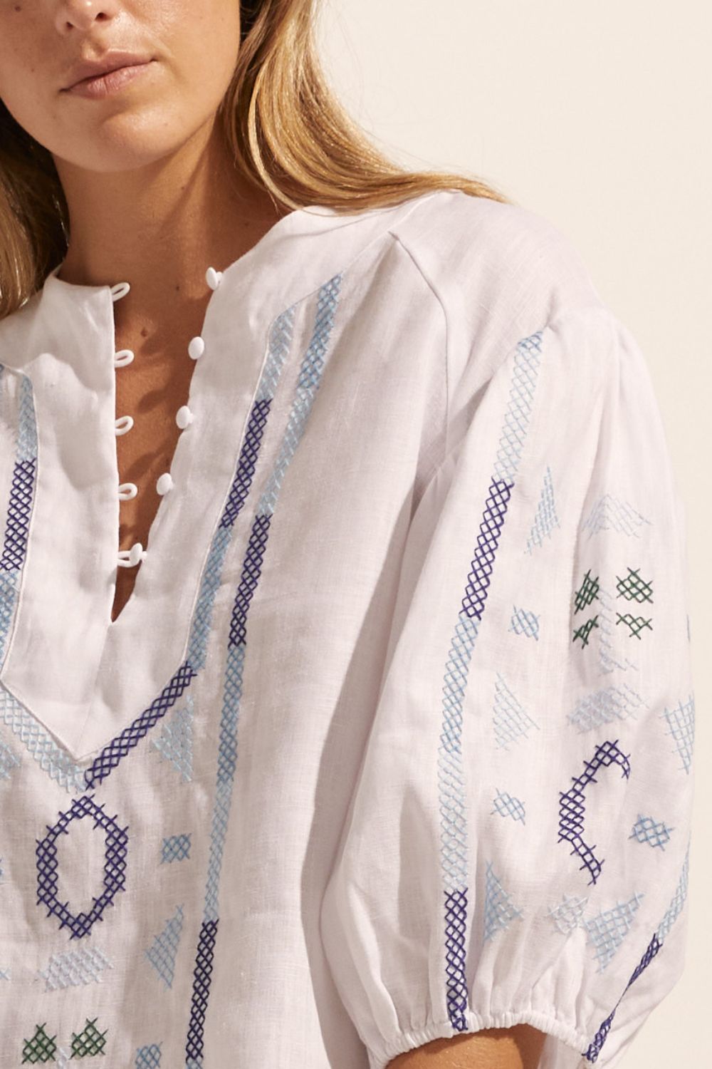 blue and white, top, mid length sleeve, button down neckline, embroidered, close up image