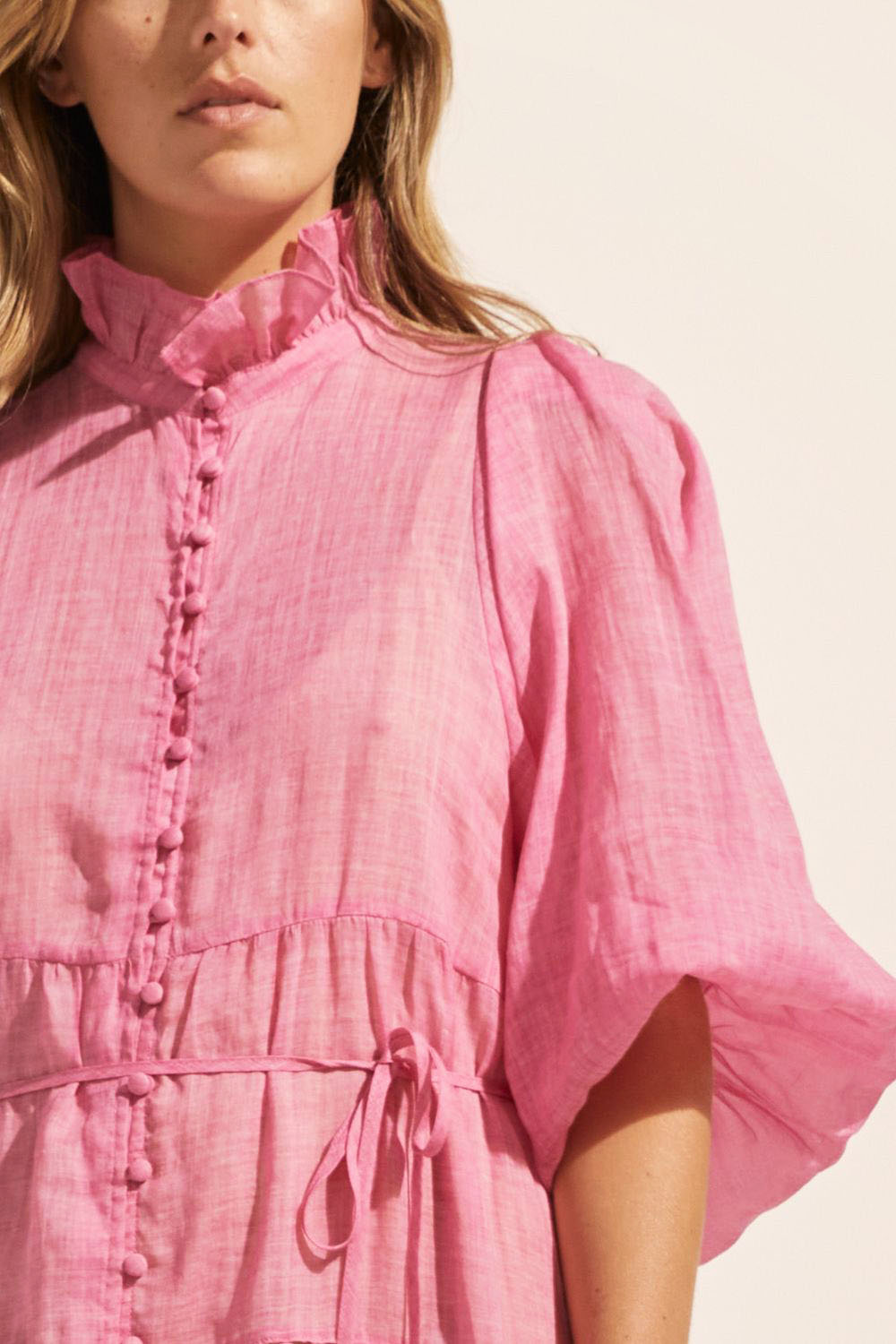 pink, dress, buttons through centre, ruffle collar, mid length sleeve, self tie fabric belt, midi dress, tiered skirt, close up image