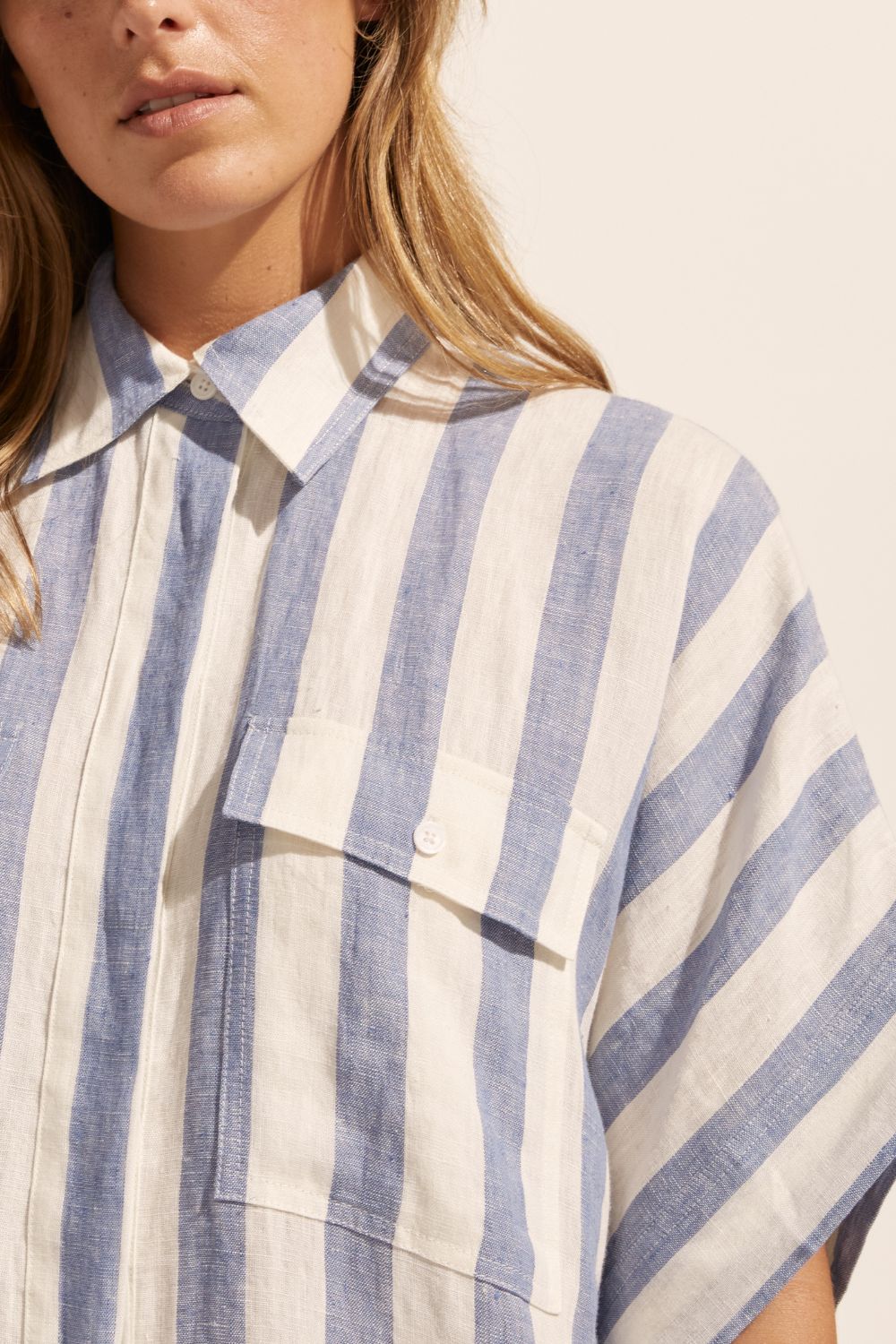 blue and white stripe, dress, mid length sleeves, oversized pockets, button down, collared dress, close up image